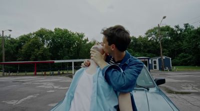 a couple of people that are sitting on a car