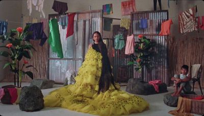 a woman in a yellow dress standing in a room