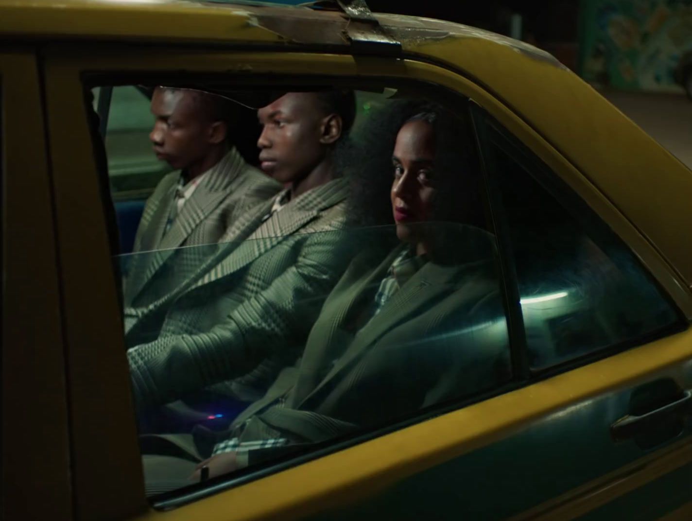 a group of people sitting in the back of a car