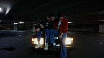 a couple of people sitting on the back of a car