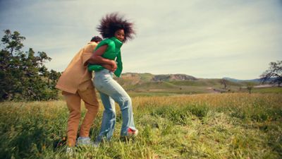 a couple of people that are standing in the grass