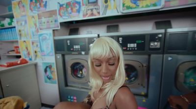 a woman in a room with a bunch of washing machines