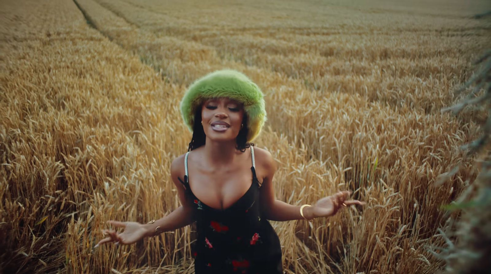 a woman standing in a field of wheat