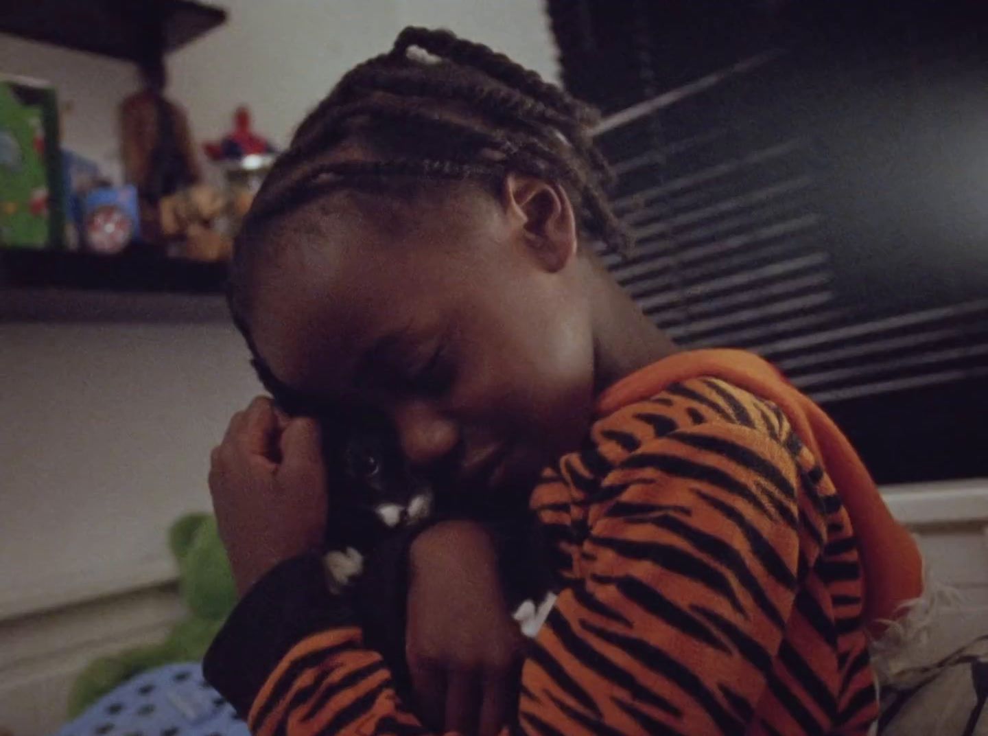 a little girl holding a cat in her arms