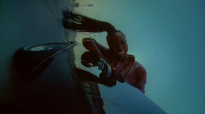 a woman holding a surfboard in her right hand