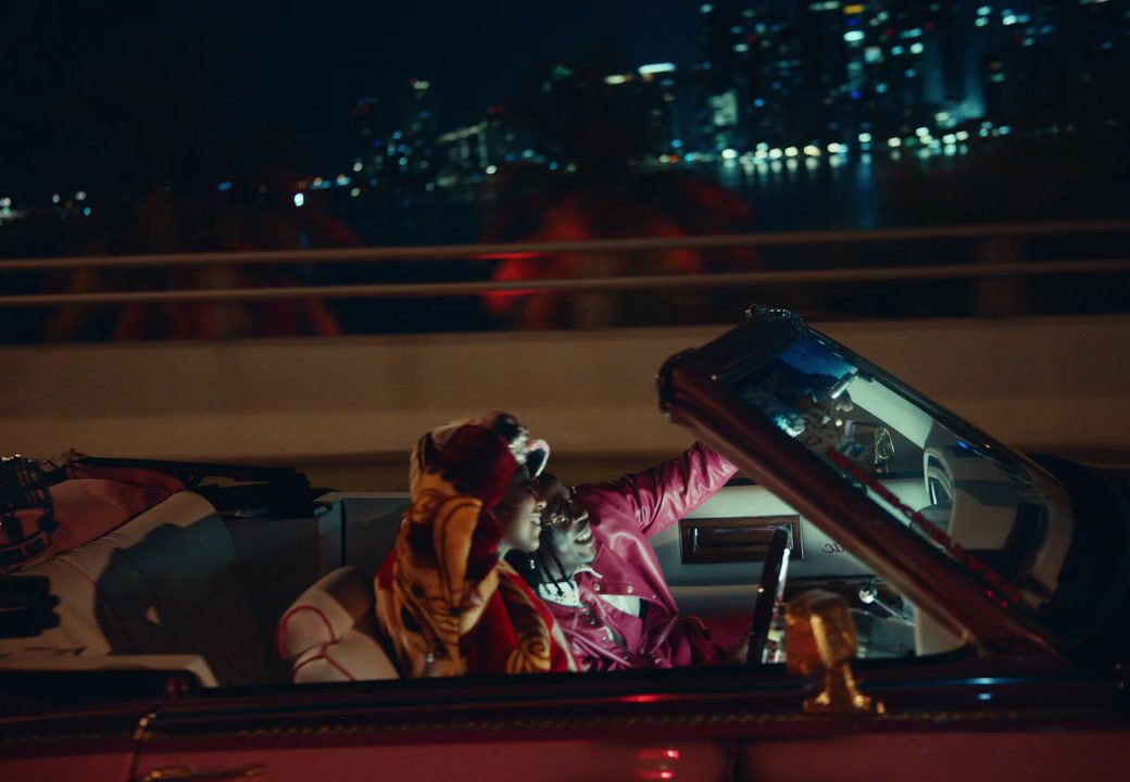 a woman sitting in a car with her hand out the window