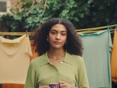 a woman holding a cup of coffee in her hands