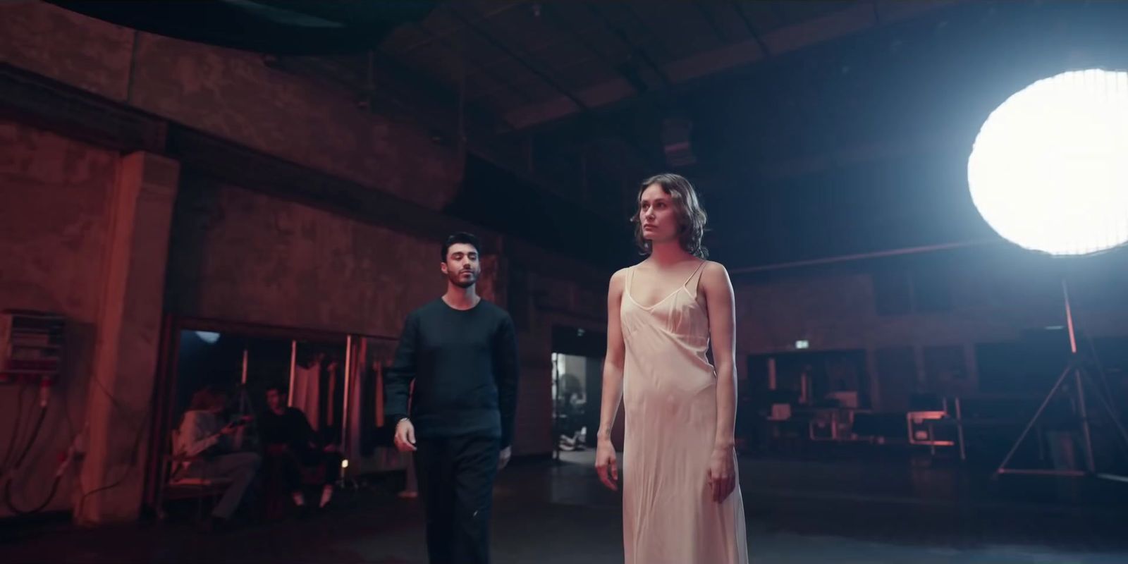 a man standing next to a woman in a white dress