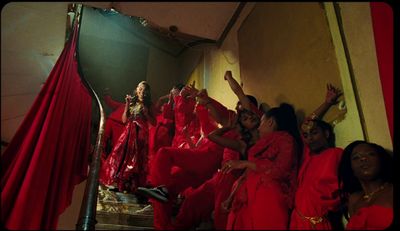 a group of women dressed in red posing for a picture