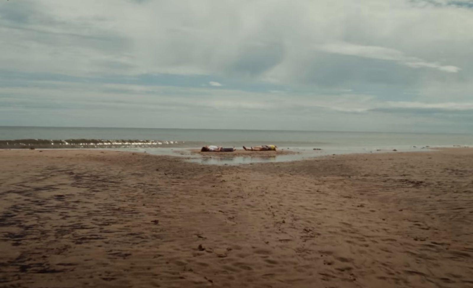 a sandy beach with a boat in the water