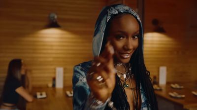 a woman with dreadlocks pointing at the camera