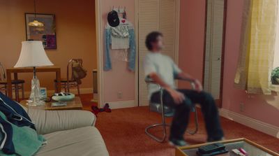 a man sitting on a chair in a living room