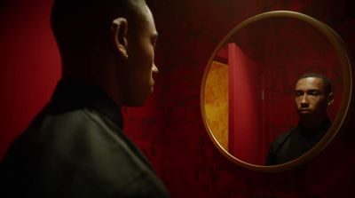 a man looking at himself in the mirror