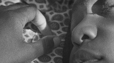 a close up of a person holding a toothbrush