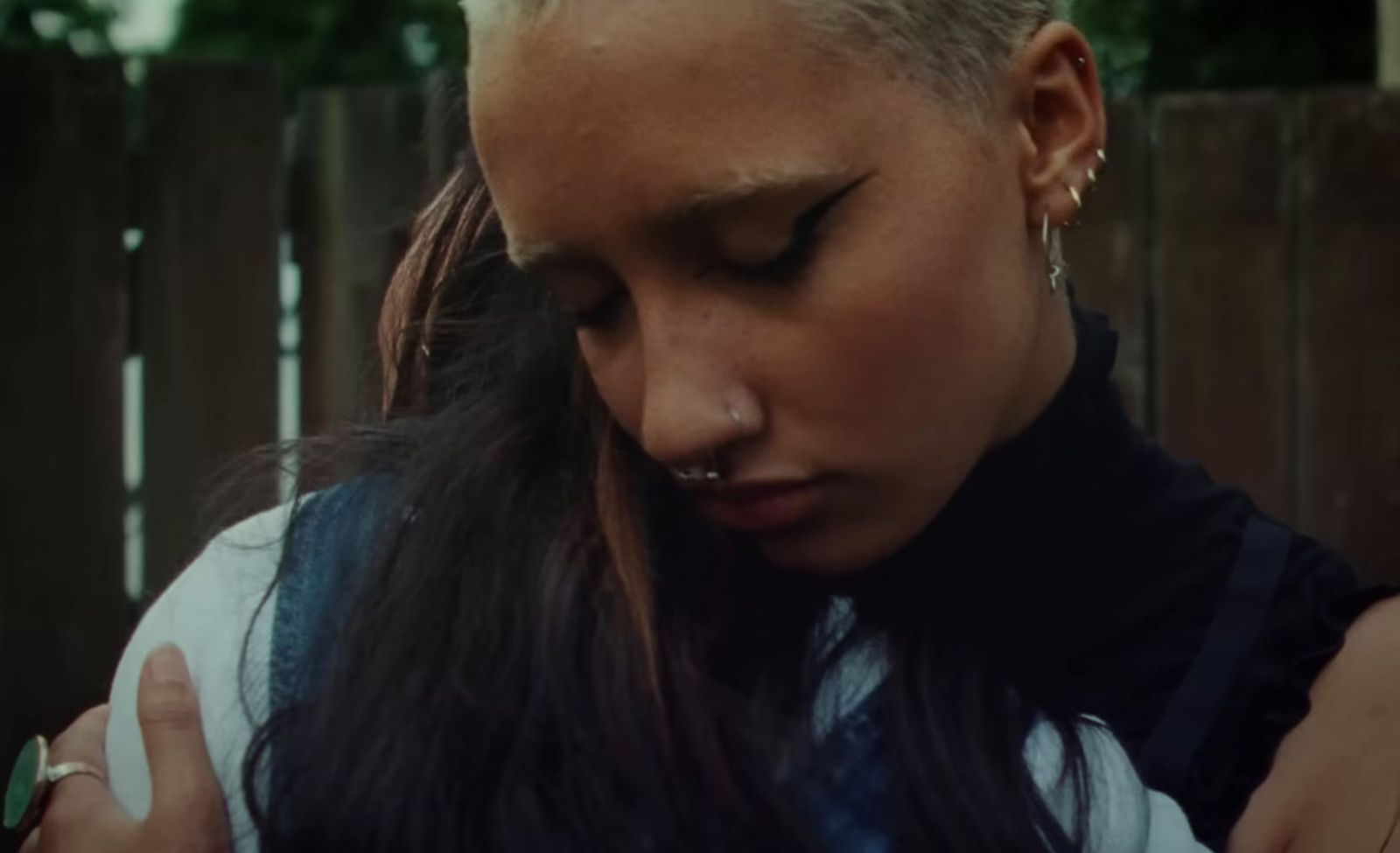 a woman with long hair and piercings on her ear