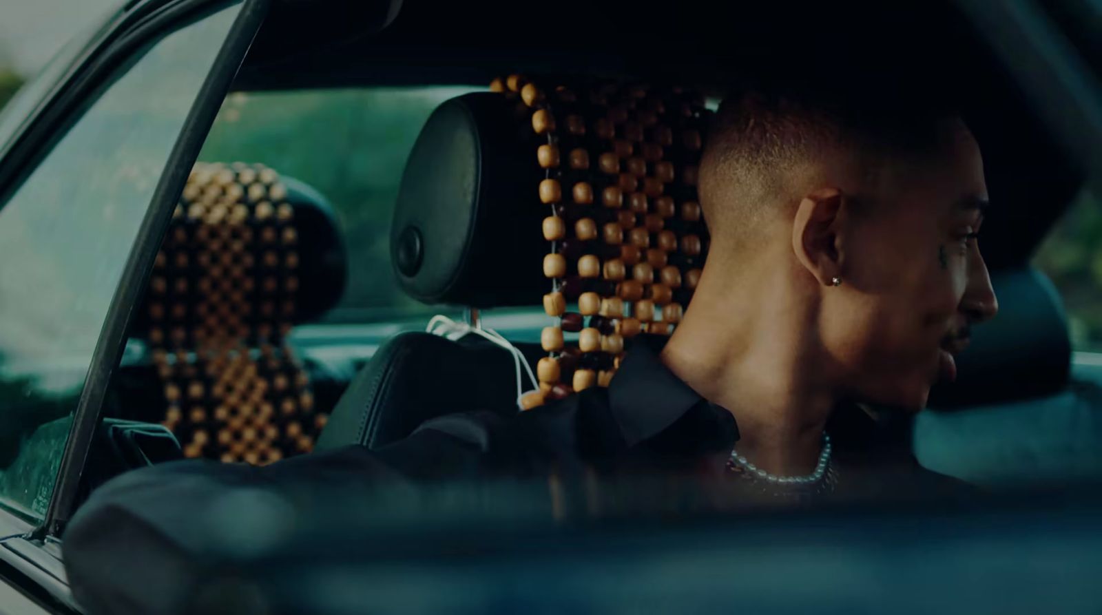 a man sitting in a car with his head out the window