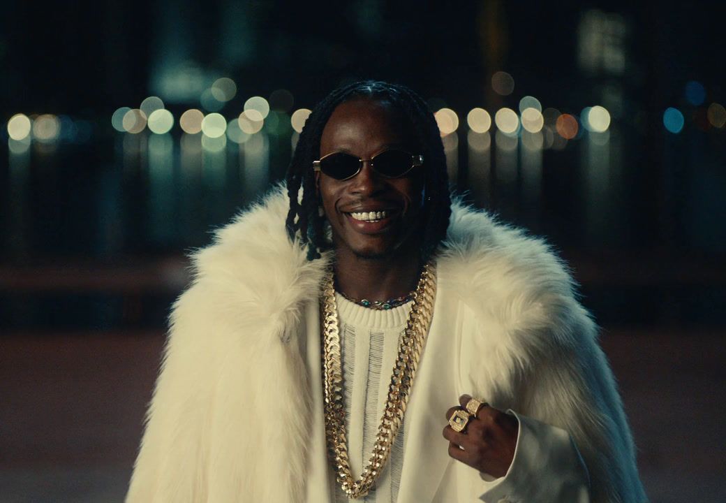 a man in a fur coat and sunglasses