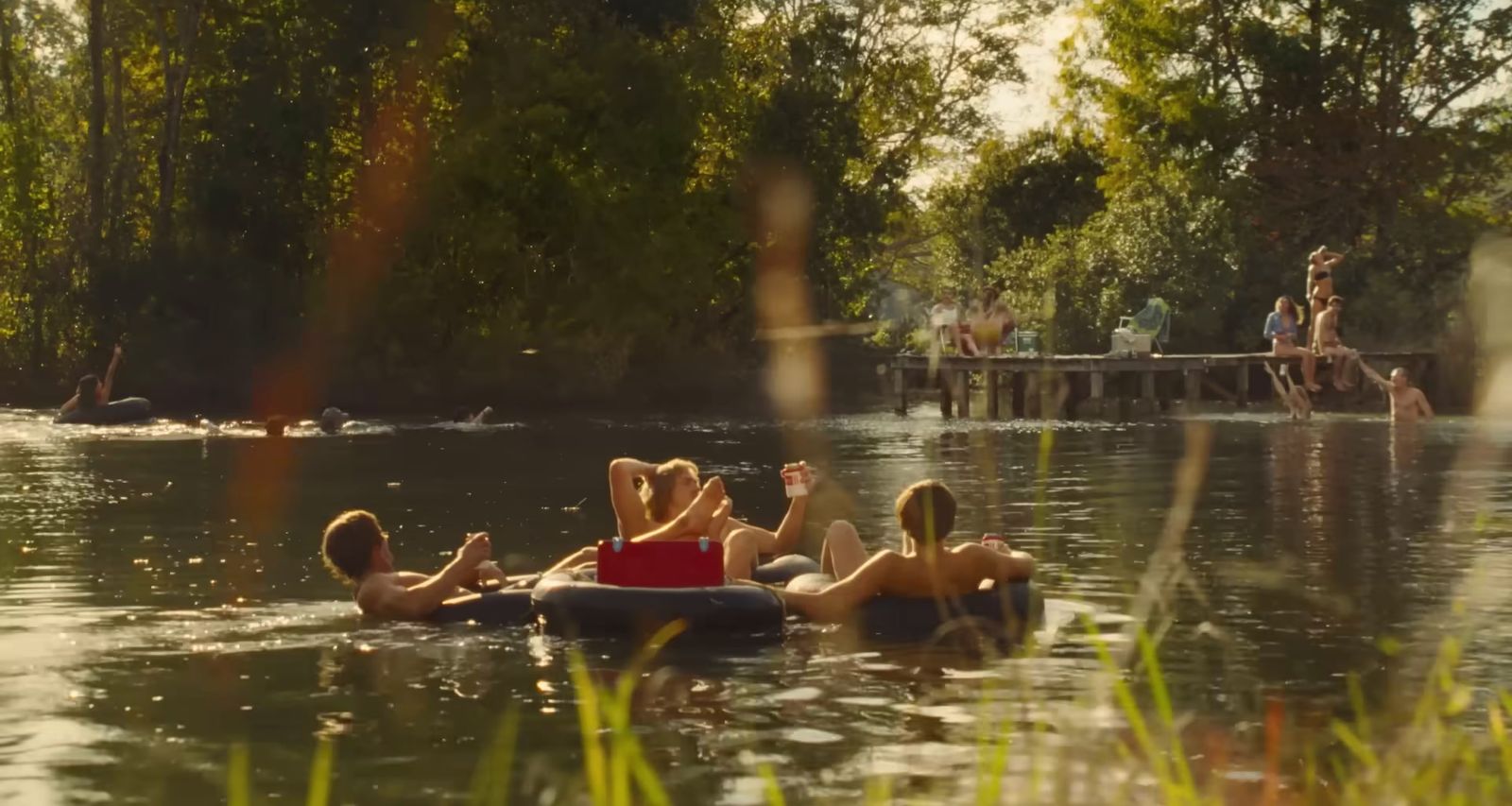 a group of people floating on top of a body of water