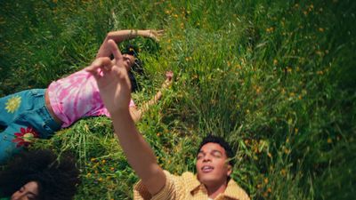 a man and a little girl laying in the grass