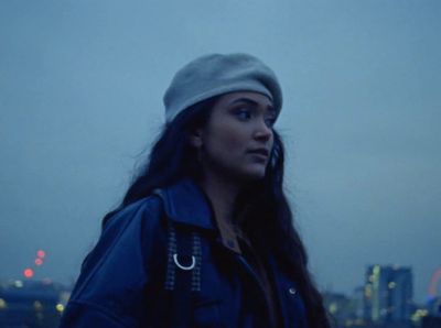 a woman standing in front of a city skyline