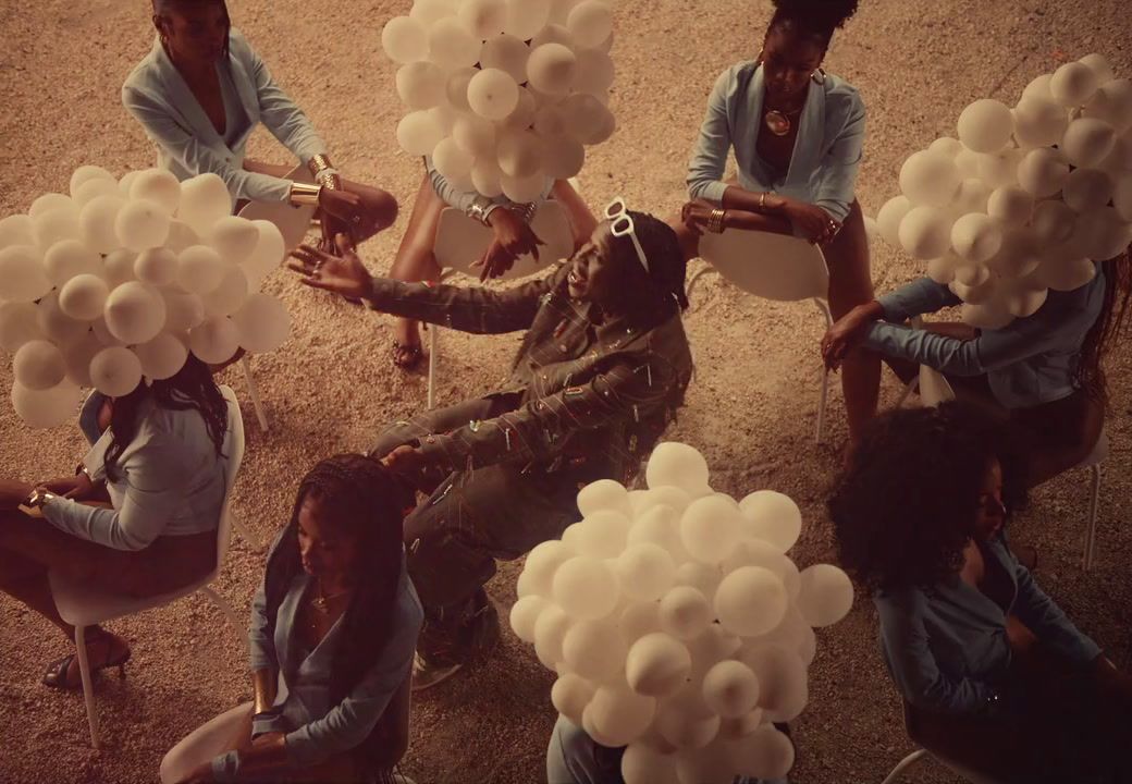 a group of people sitting around each other holding balloons