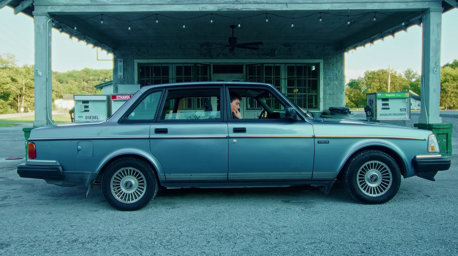 a blue car parked in front of a building