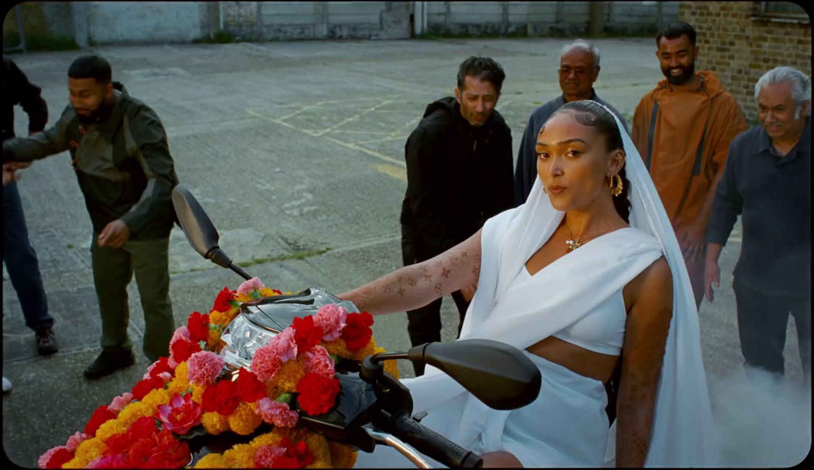 a woman in a white dress on a motorcycle