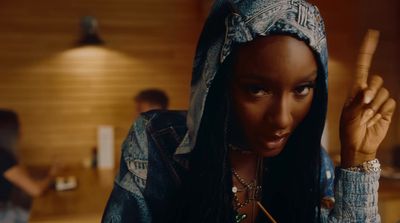 a woman with long black hair wearing a bandana