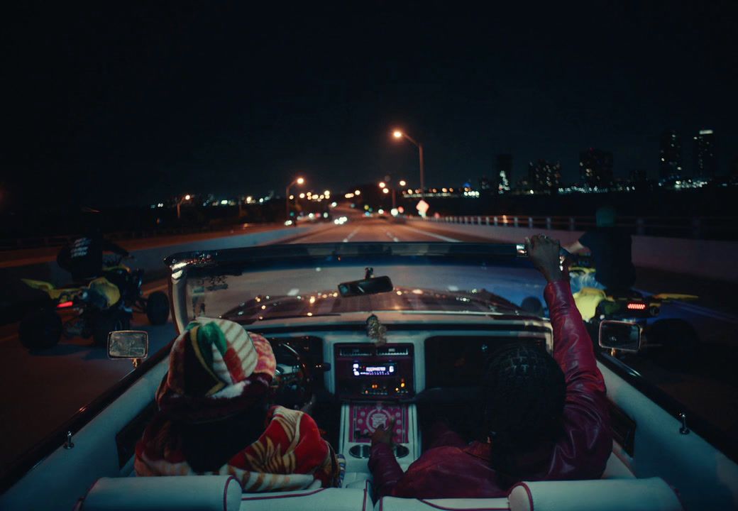 a person sitting in the back of a car at night