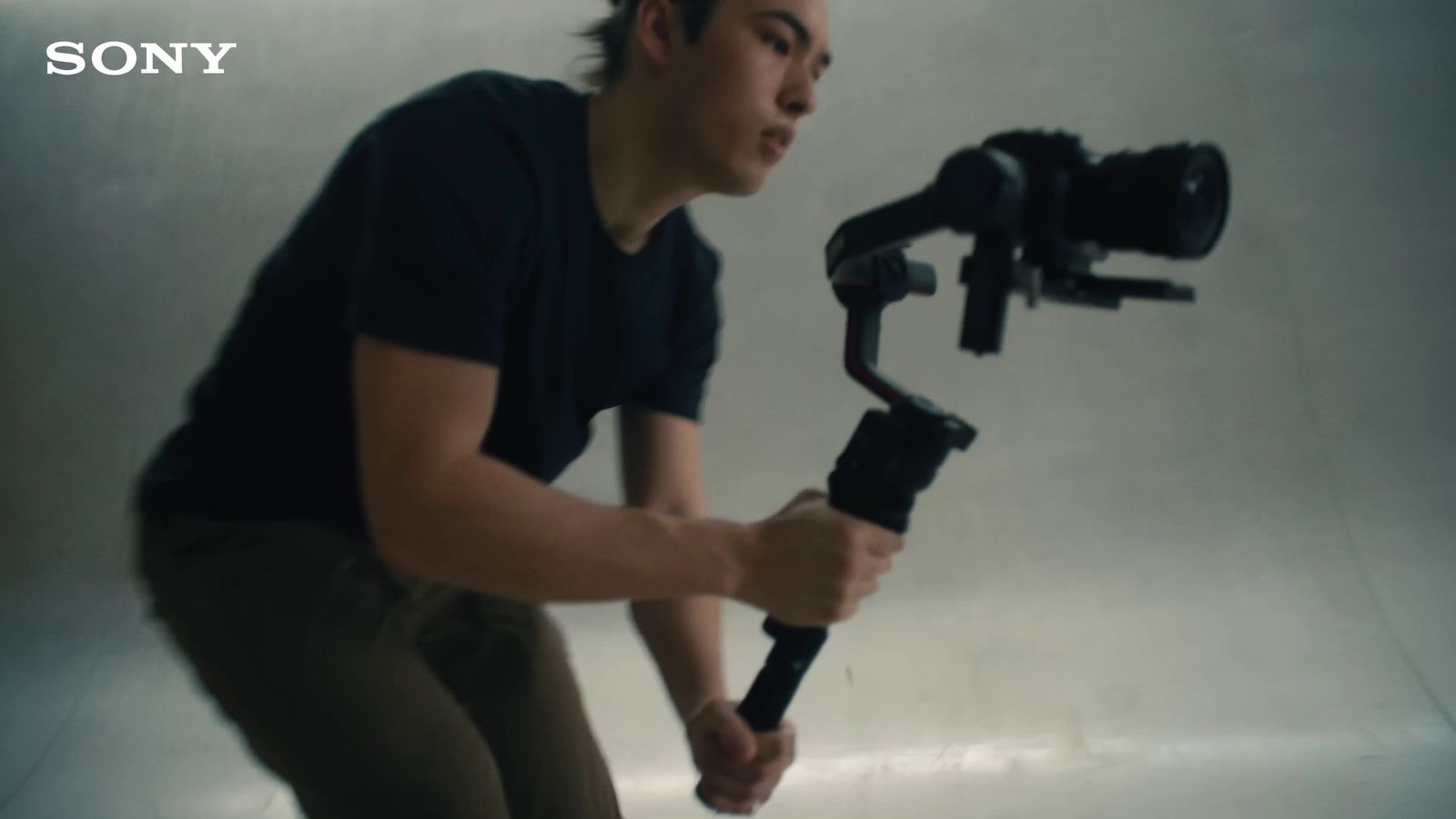 a man holding a camera and a tripod