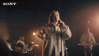 a woman standing in front of a microphone