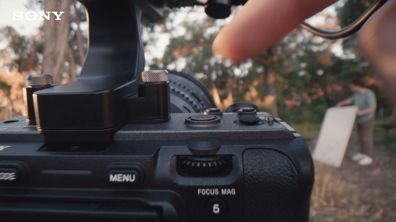 a close up of a camera with a person in the background