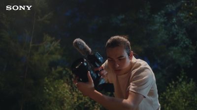 a woman holding a camera in front of her face