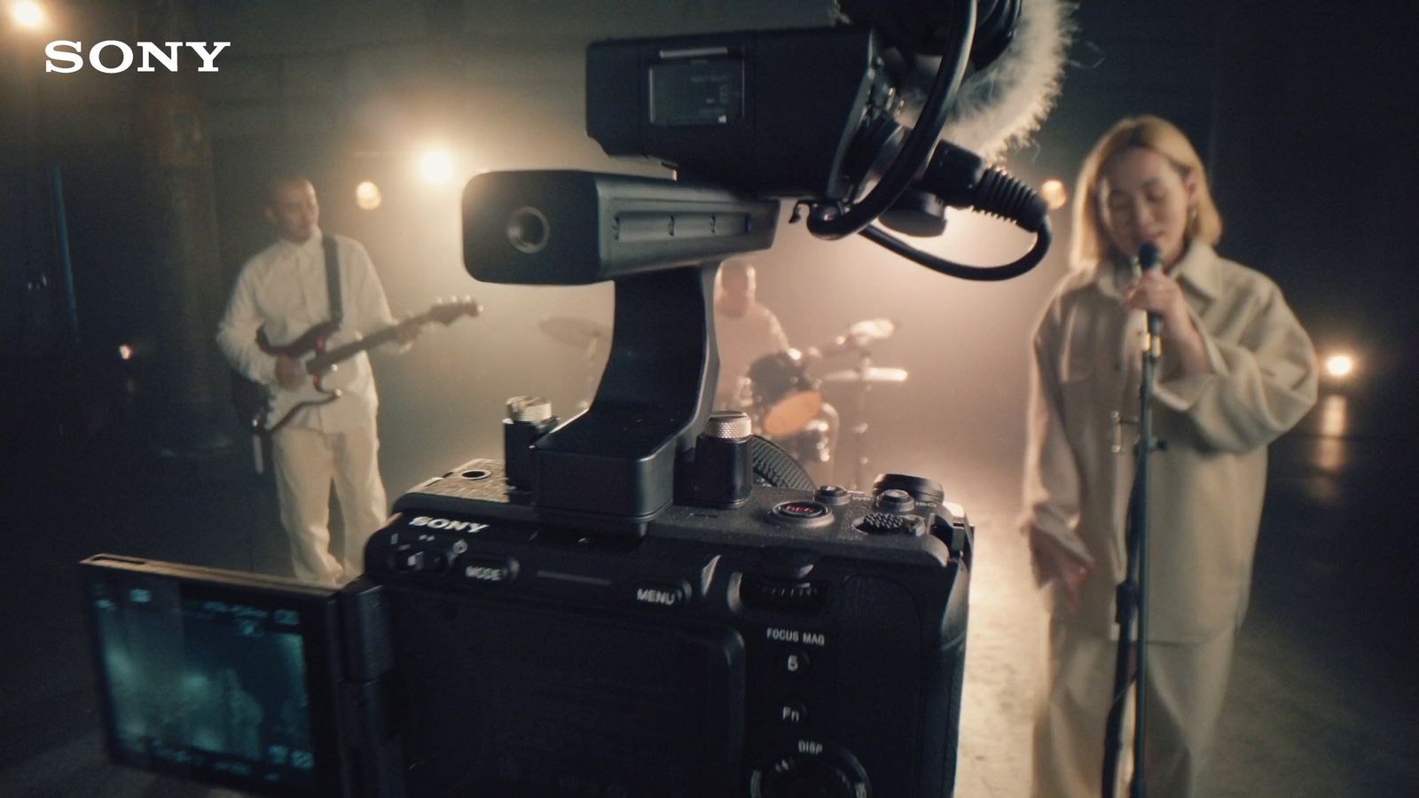 a woman standing in front of a camera with a microphone