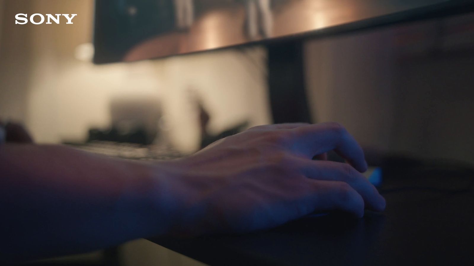 a person typing on a computer keyboard with a blurry background