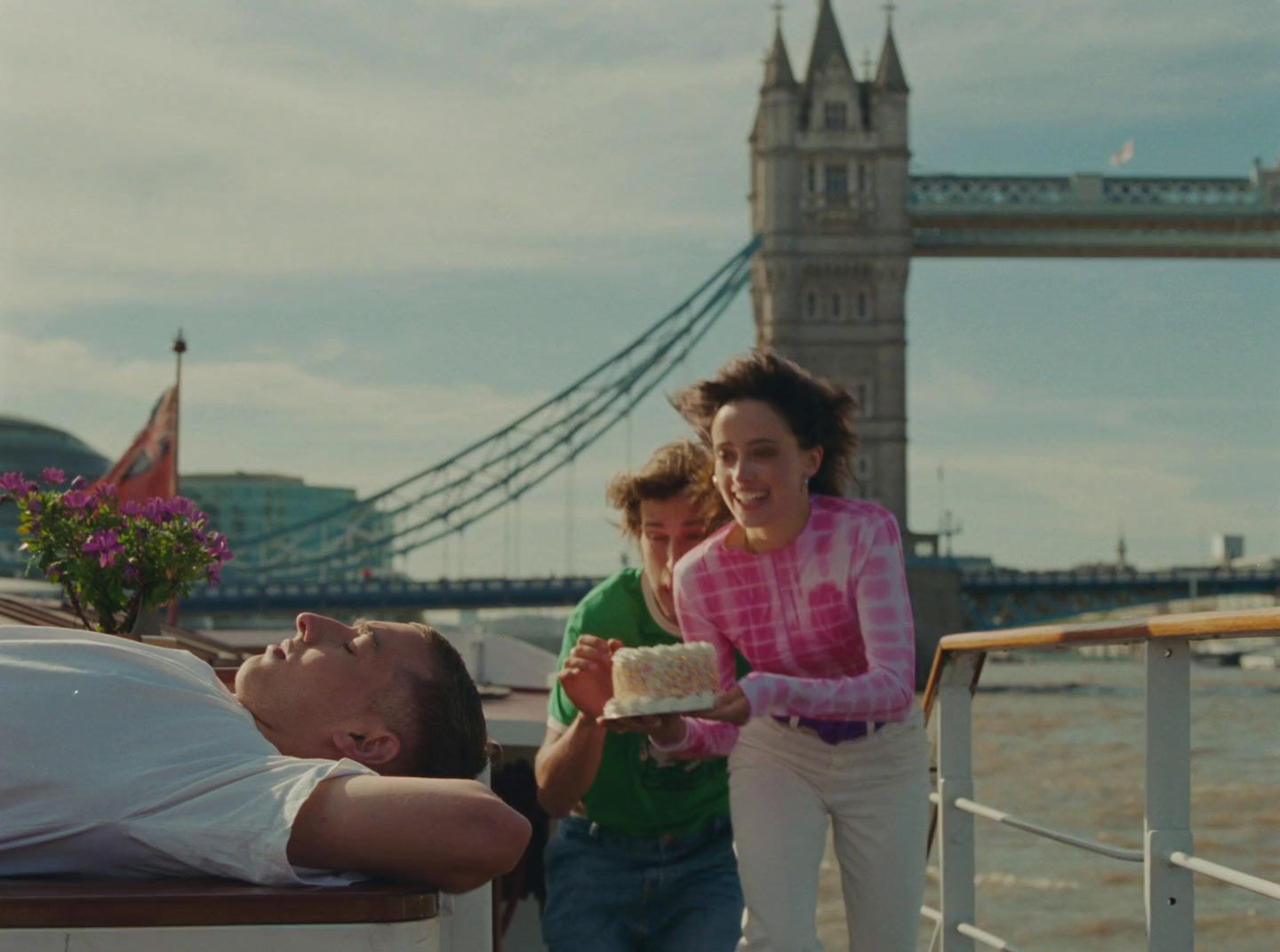 a man and a woman eating cake on a boat