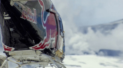 a close up of a helicopter with a mountain in the background