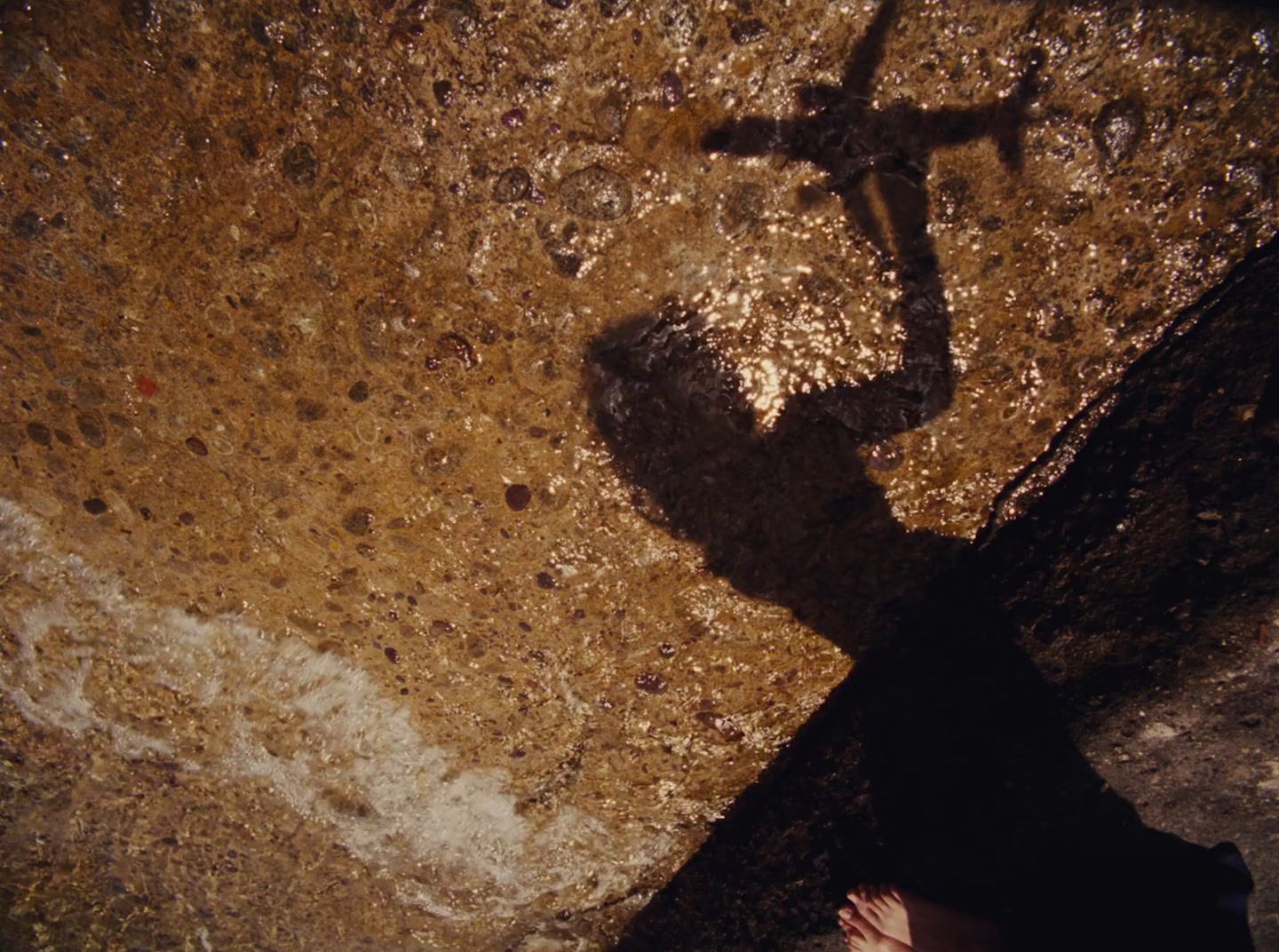 a person standing next to a cross on the ground