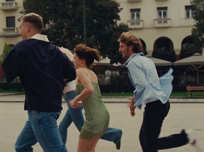 a group of people running in the street