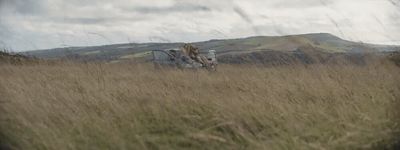 a blurry photo of a person riding a horse in a field