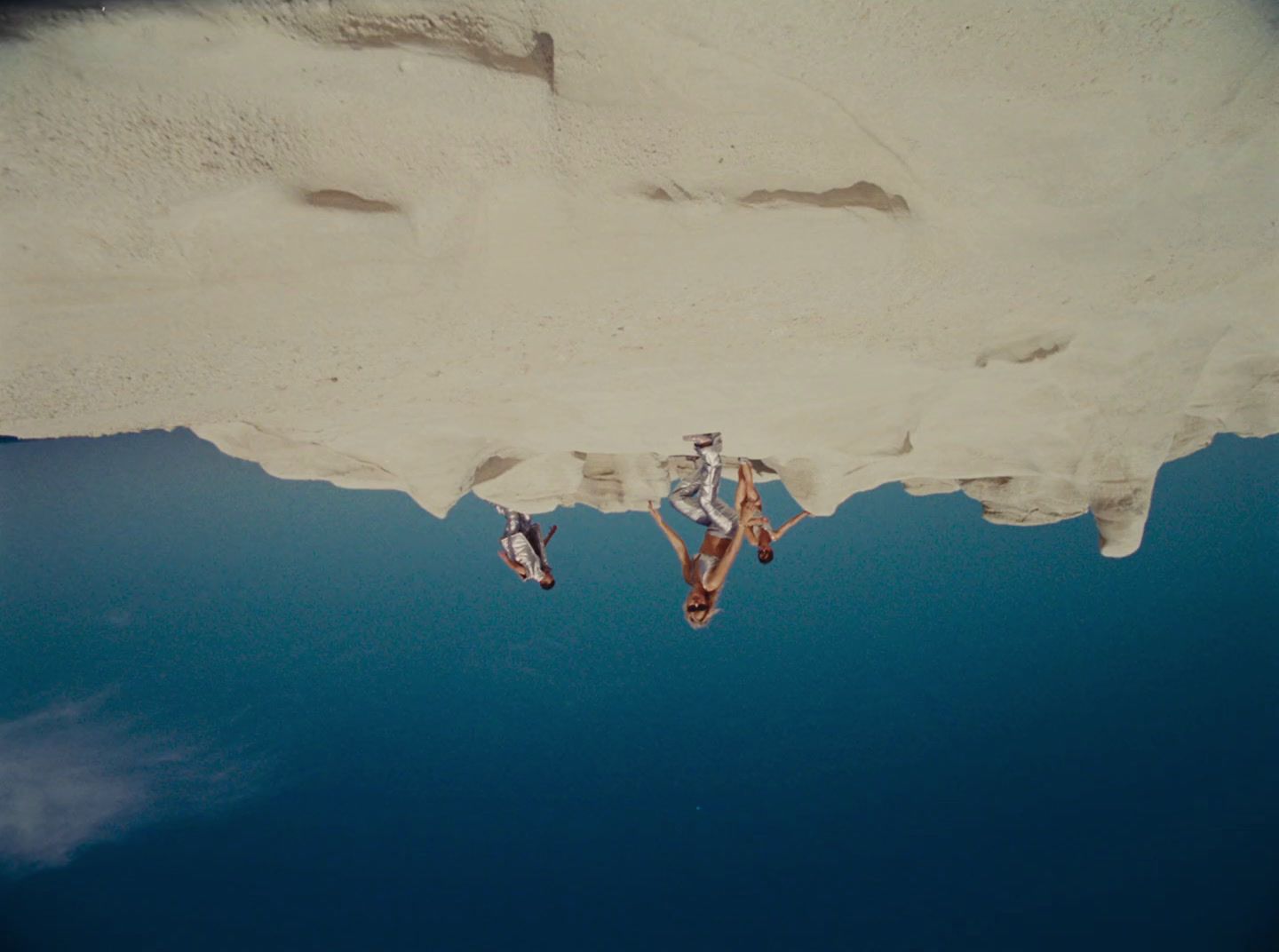 a couple of people floating on top of a body of water