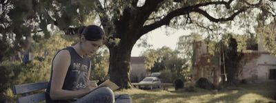 a woman sitting on a bench reading a book