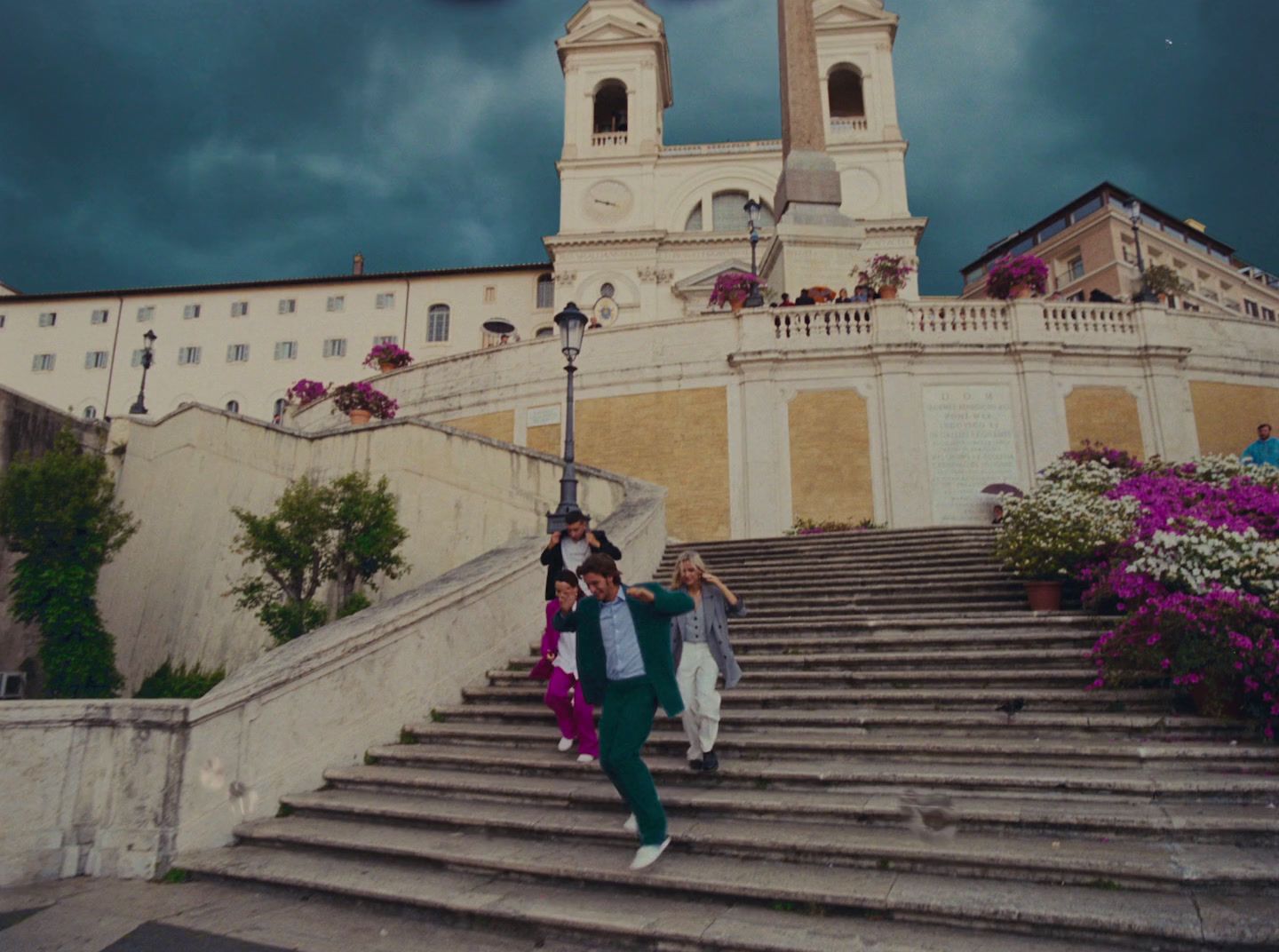 two people walking up a set of stairs in front of a building