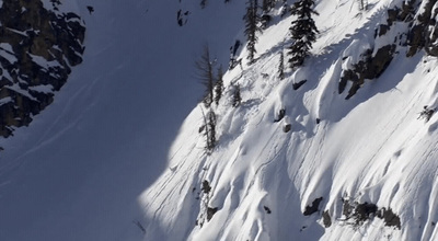 a person skiing down a snow covered mountain