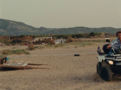 a man riding on the back of a four wheeler