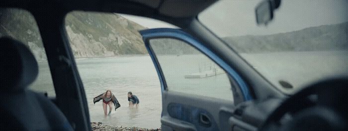 a couple of people are standing in the water