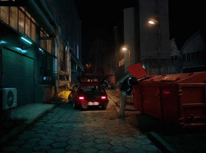 a car parked on the side of a street at night