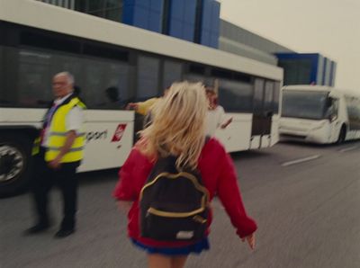 a woman walking down a street with a backpack