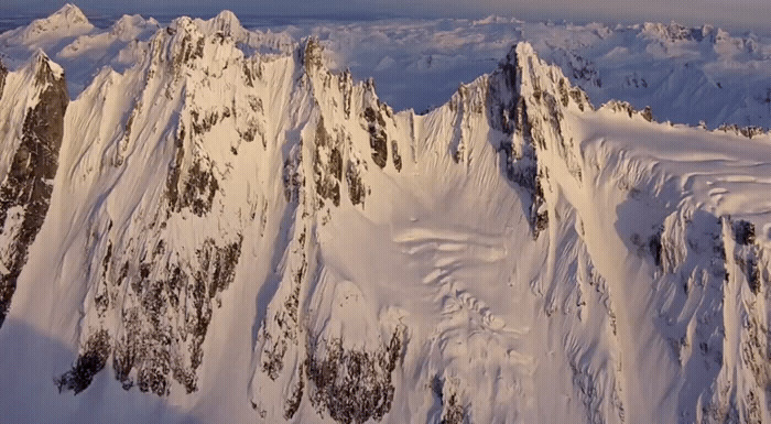 a view of the top of a mountain covered in snow