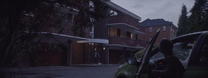 a couple of cars parked in front of a building